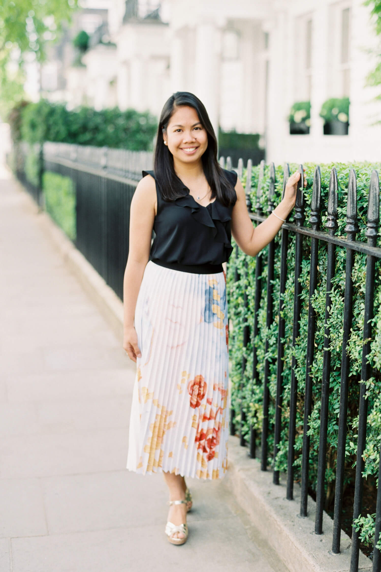 Cristina Ilao Destination Wedding Photographer - Filipino woman in late thirties dressed in ruffled black silk deep V neck blouse and a Kamiseta x Heart Evangelista pleated skirt